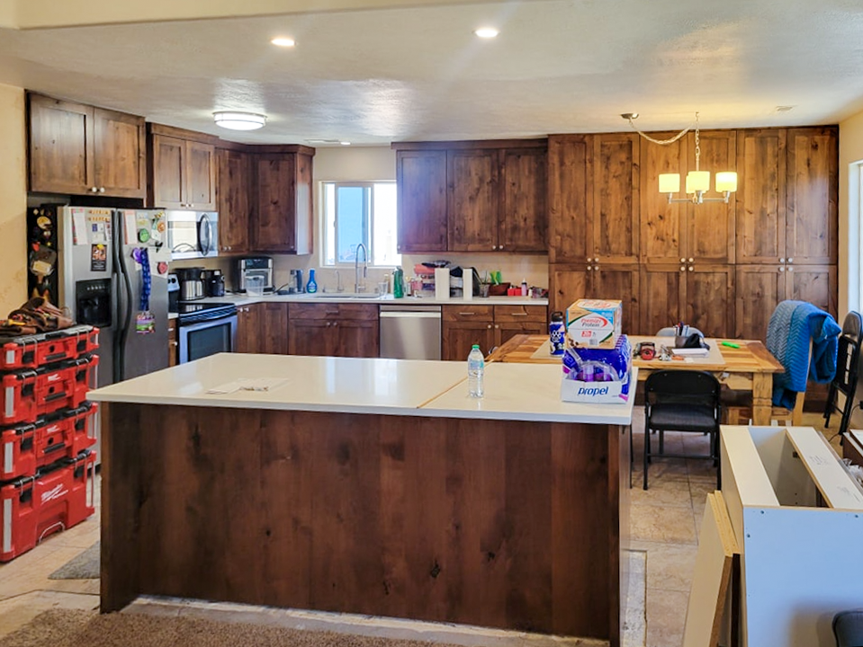 Custom knotty alder kitchen island with white countertop