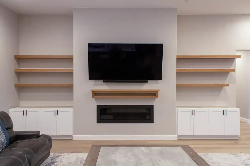 A beautiful custom living room floating shelf and mantle that was designed, built and installed by Haggerty Construction.