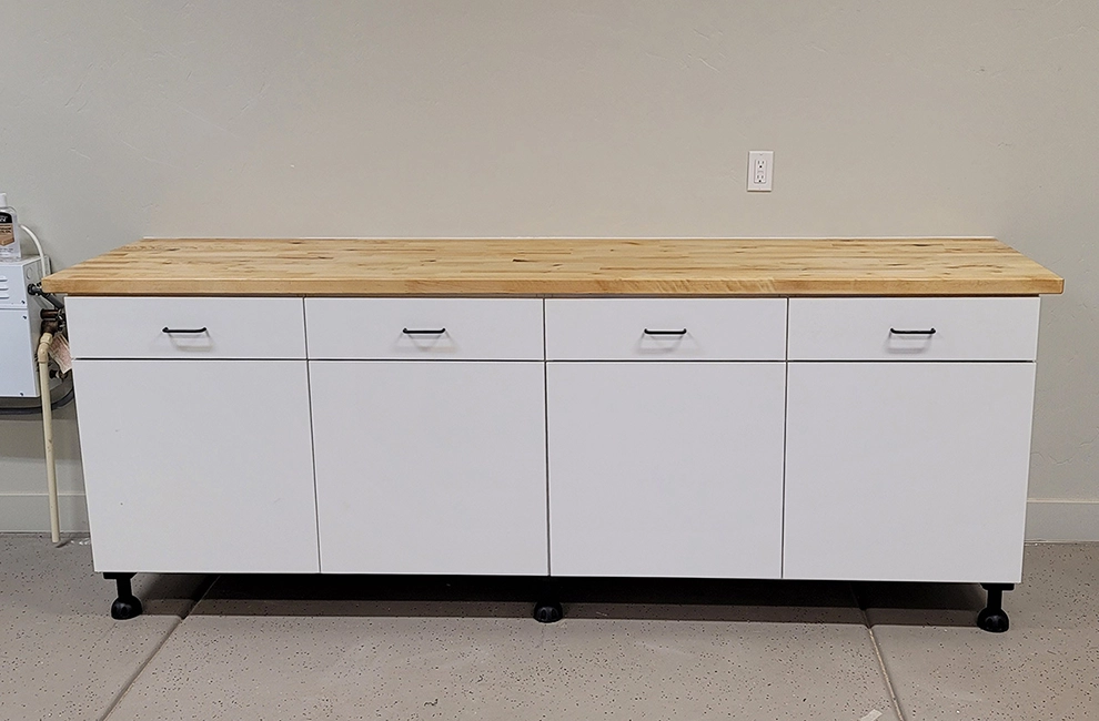 Custom garage cabinets with a butcher block top, designed and installed by Haggerty Construction.