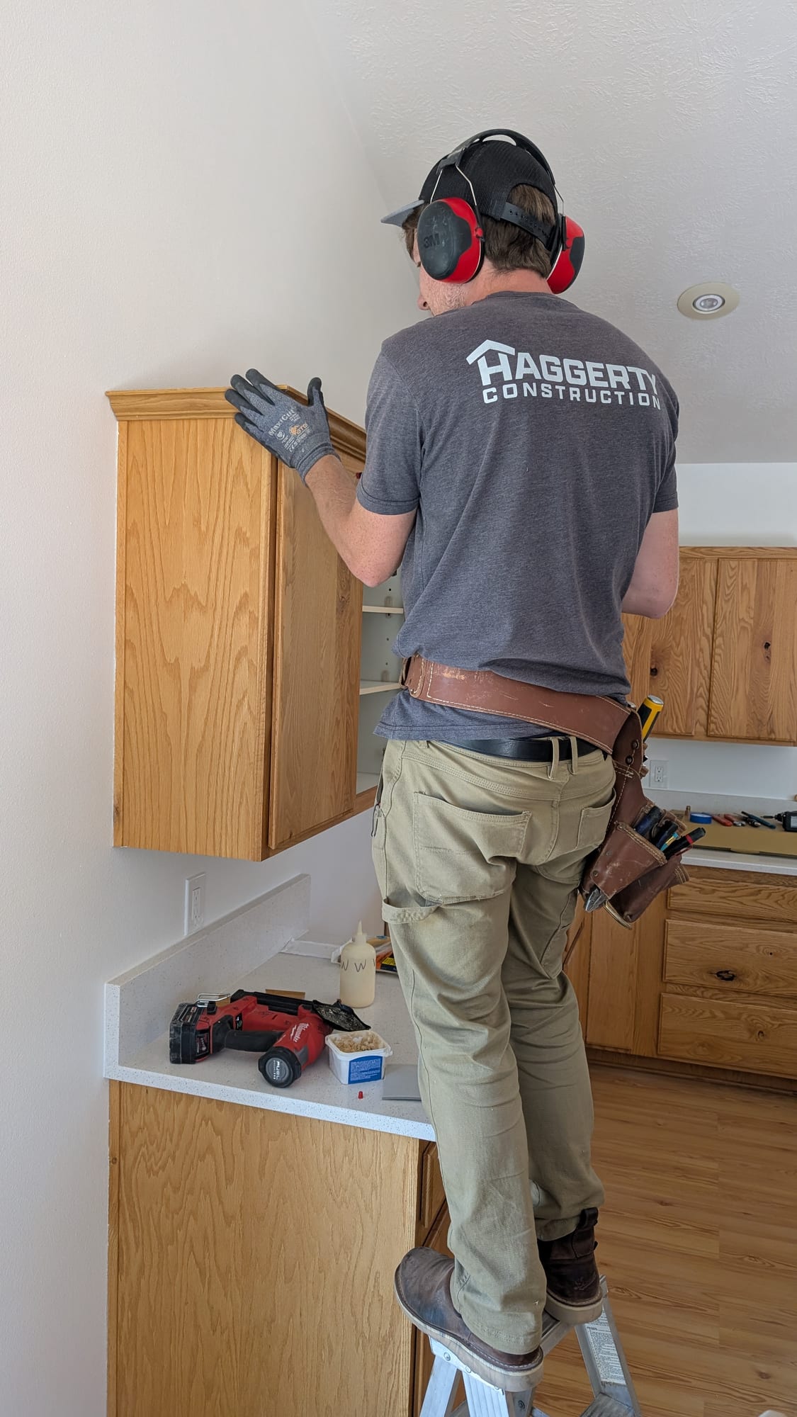 Haggerty Construction craftsman installing kitchen cabinets