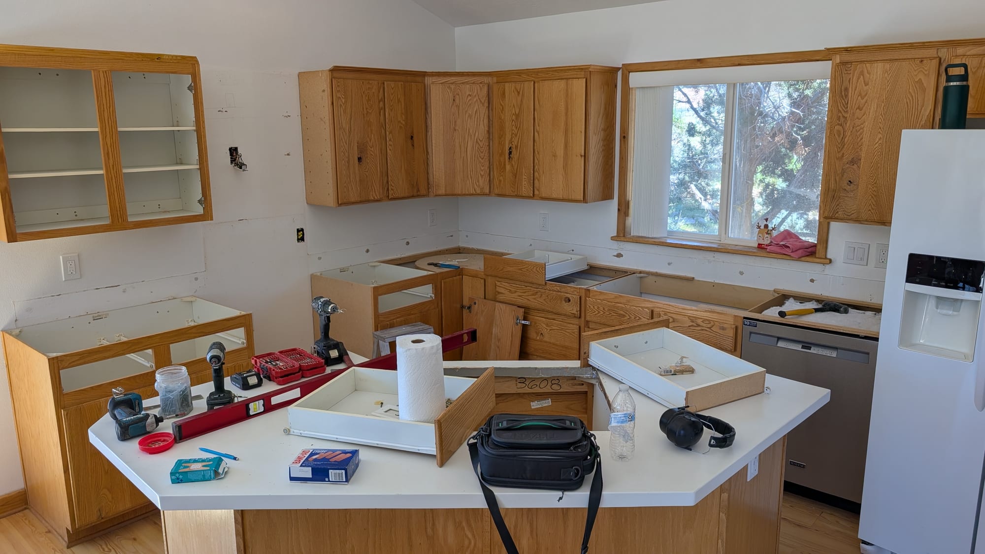 Kitchen mid-demolition with original cabinets being removed by Haggerty Construction