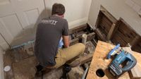 Bathroom floor opened up to the joists, with new plumbing going in