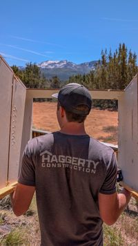Blake Haggerty carrying a cabinet during demolition