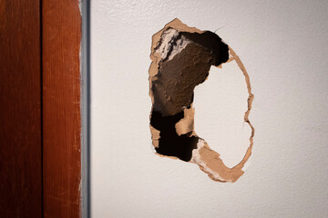 An unfortunate hole in the drywall in need of repair.