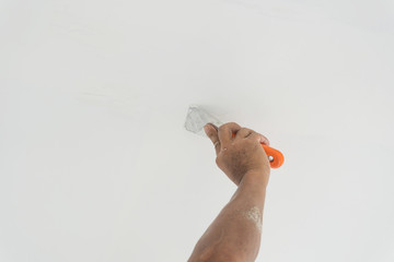 Applying mud to the drywall.