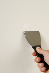 Applying mud to the drywall.