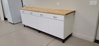 Full garage cabinet system with workbench and overhead storage