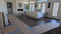 Living room during a whole-home remodel — floors covered, furniture protected by Haggerty Construction