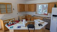 Kitchen mid-demolition with original cabinets being removed by Haggerty Construction