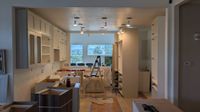 Kitchen remodel in progress with new cabinetry, island, and lighting