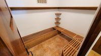 Teak slat benches and corner shelves in a pool-house changing room at The Ledges