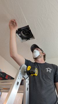 Haggerty Construction crew member installing a ceiling fan housing
