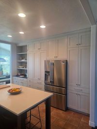 Floor-to-ceiling pantry cabinets around a built-in fridge in a St. George-area kitchen remodel
