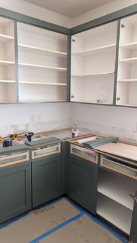 Sage-green cabinets being installed during a whole-home remodel